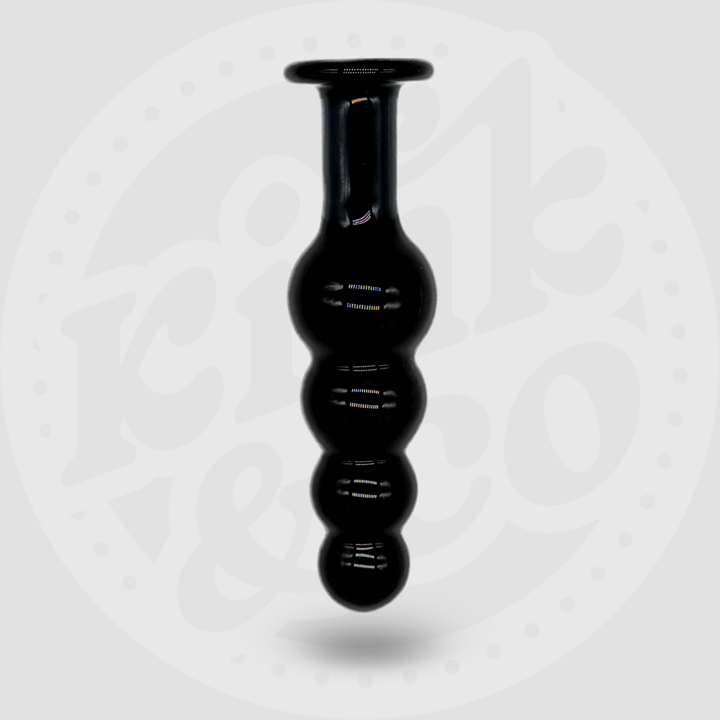 Large black glass beaded sex toy with flat handle stood upright with a white and grey background showing the logo for Kink&Co