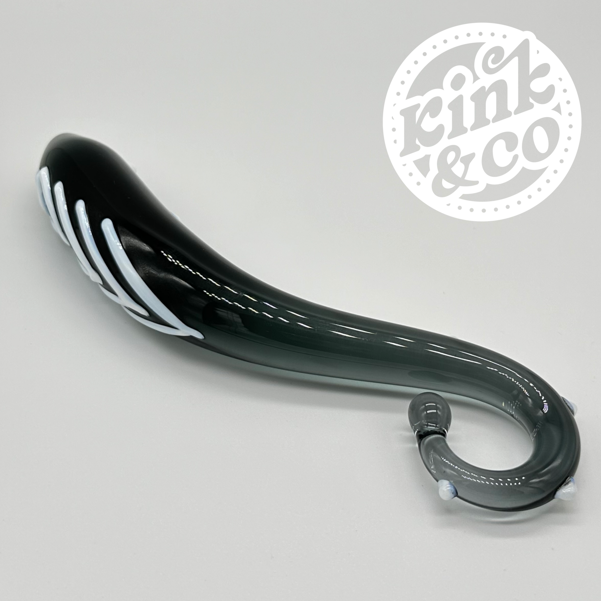 Black glass sex toy on its side showing the curved handle. On a grey background with the kink and co logo in the top right 